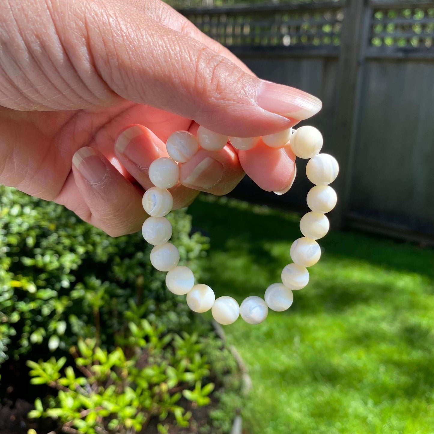 Mother of Pearl Bracelet-Gemstone Jewelry This bracelet is made with mother of pearl and stretchy elastic. Packaging: This bracelet will come to you in an organza gift bag, along with an information sheet on the various crystal meanings. Properties:Mother