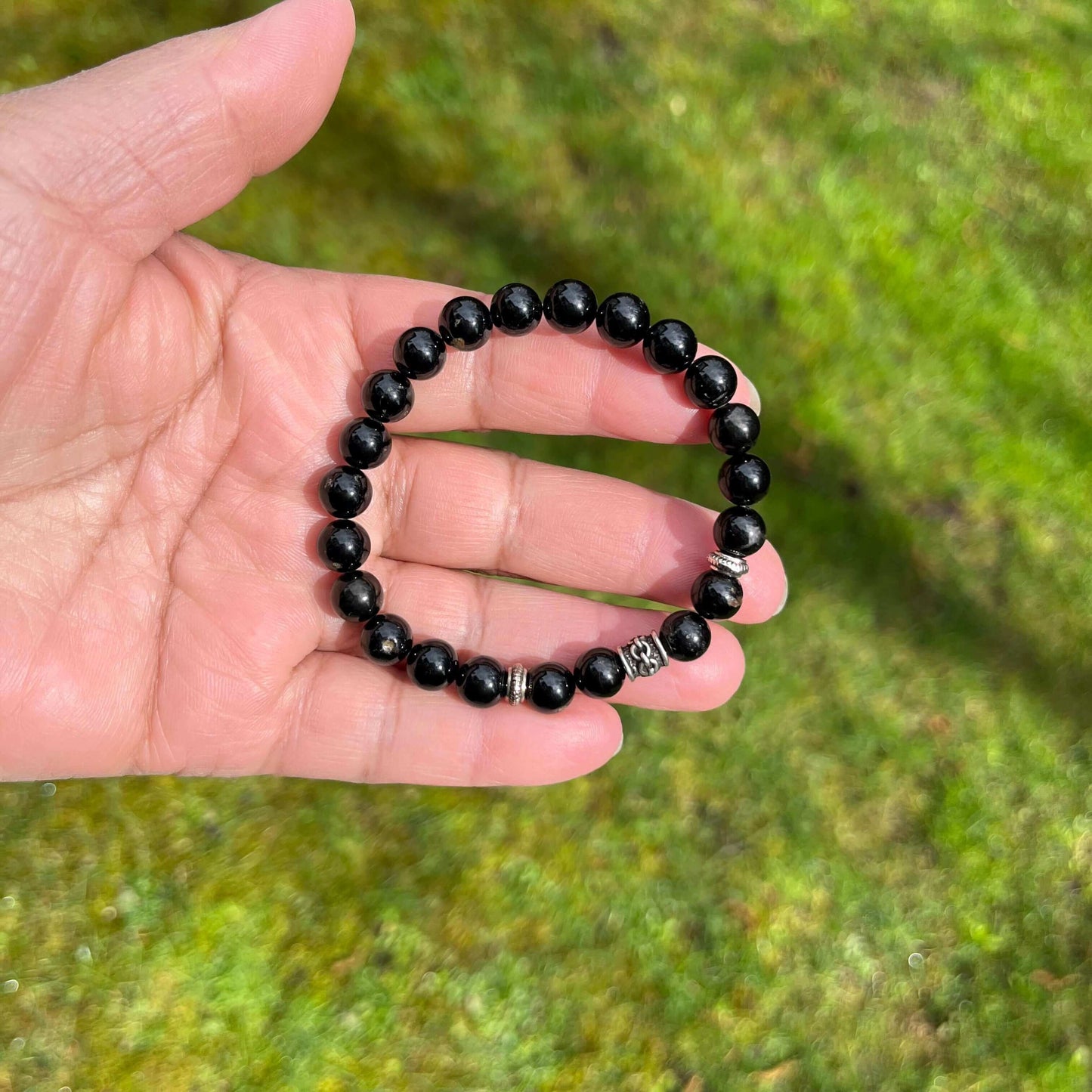 Jet Bracelet-Gemstone Jewelry This bracelet is made with black jet beads, one antique silver pewter spacer, two disk metal spacers and stretchy elastic. Packaging: This bracelet will come to you in an organza gift bag, along with an information sheet on t